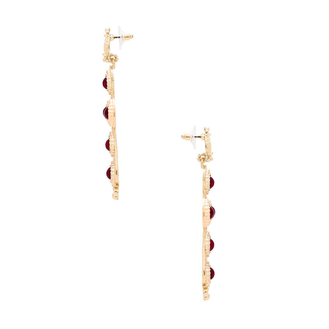 Gold and red earrings on a white background