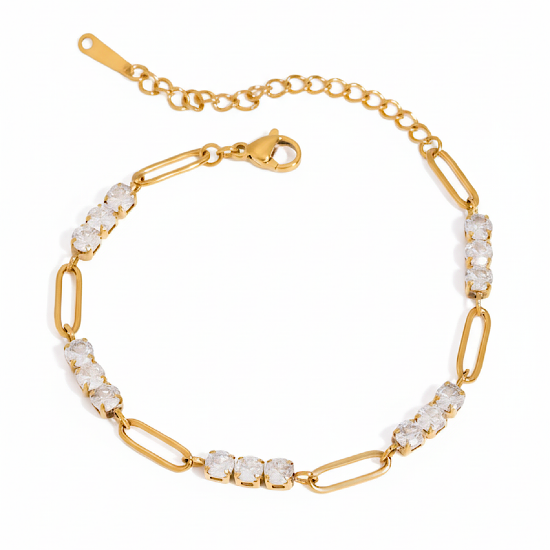 Gold bracelet with clear gemstones on a white background