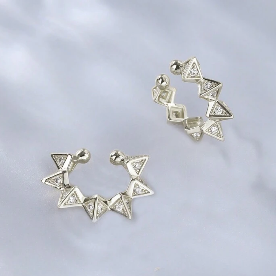 Pair of silver triangle earrings on a light gray background