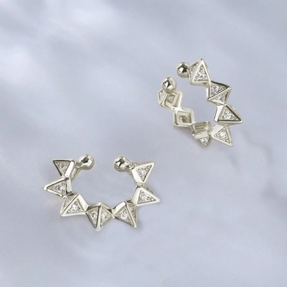 Pair of silver triangle earrings on a light gray background