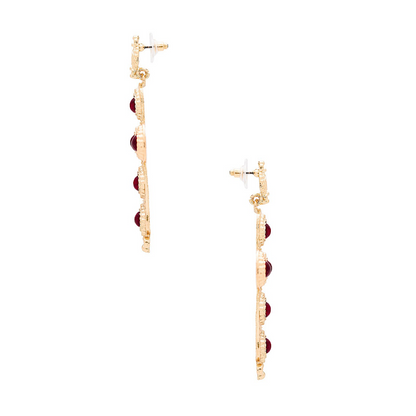 Gold and red earrings on a white background