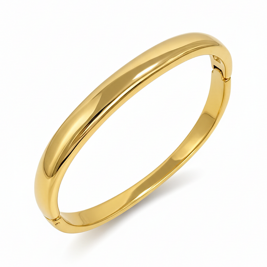 Gold bangle on a white background