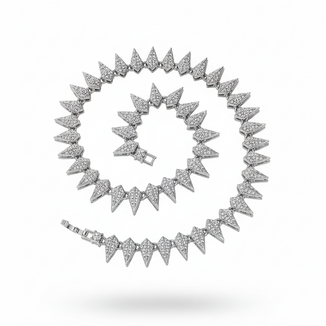 Silver necklace with spike-like design on a white background