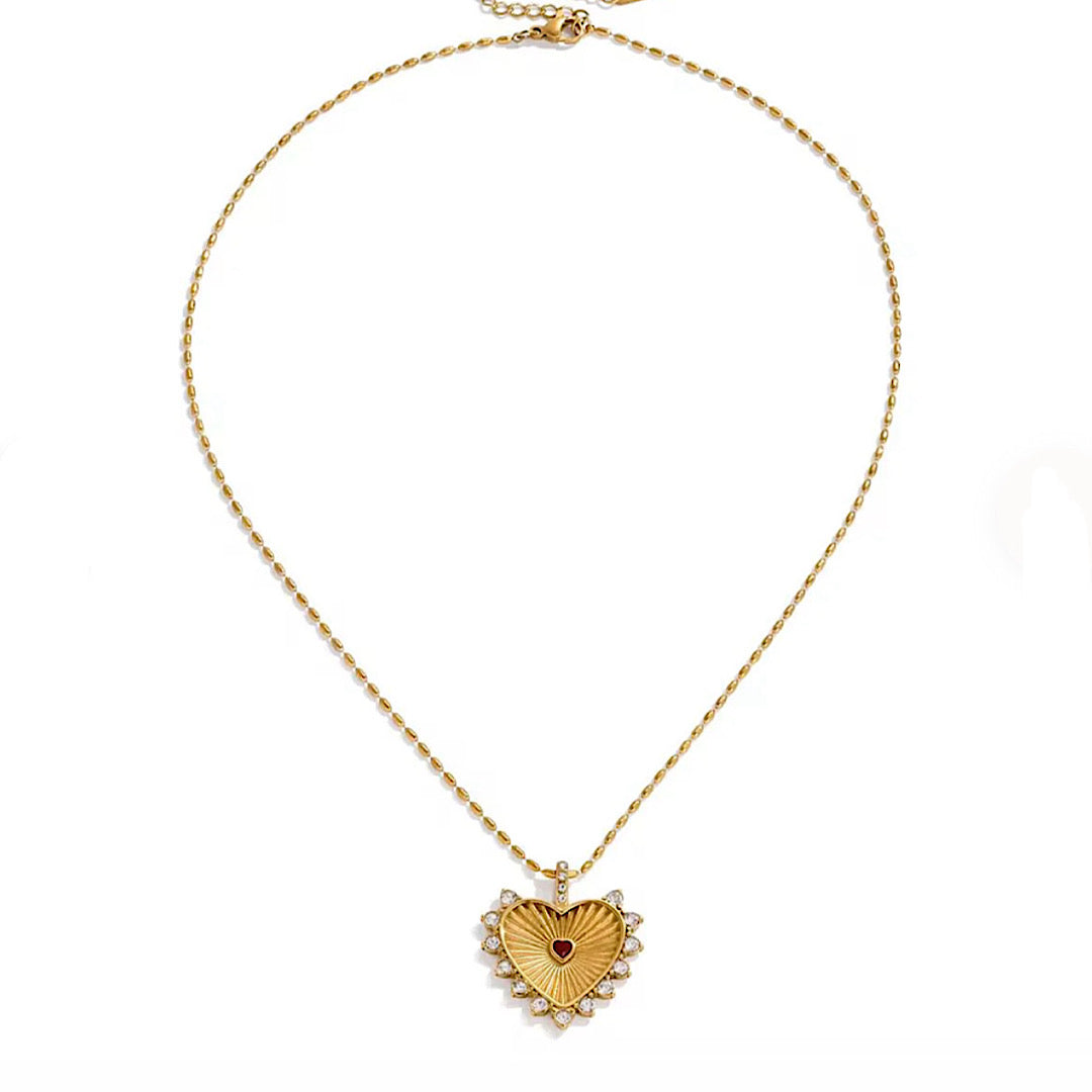 Gold heart-shaped pendant necklace on a white background